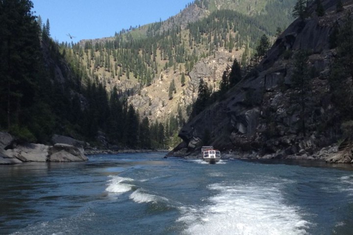 a body of water with a mountain in the background